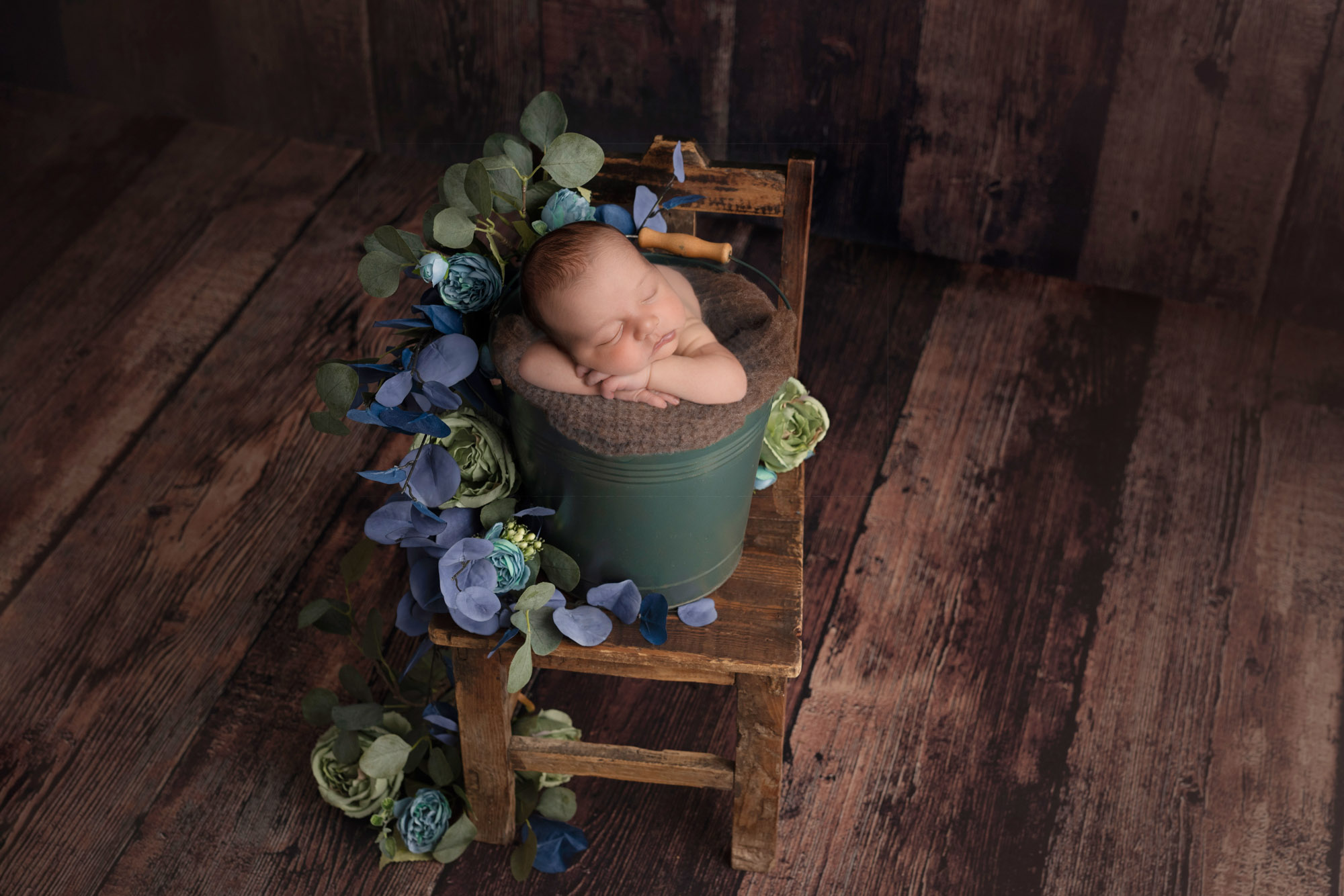 Newborn boy In a bucket