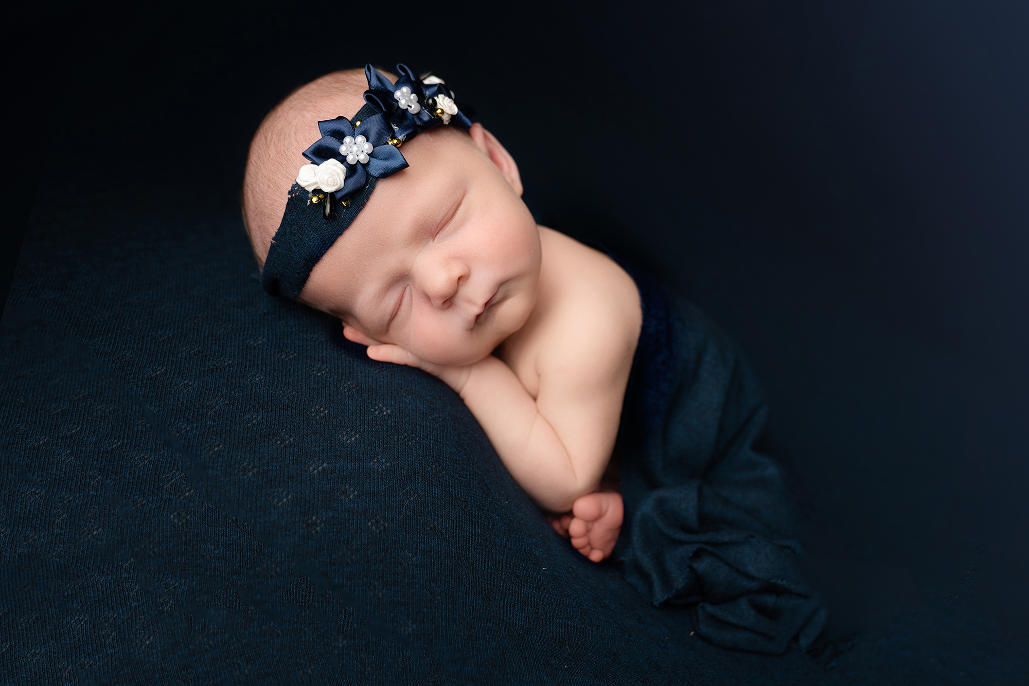 Sleeping newborn in blue