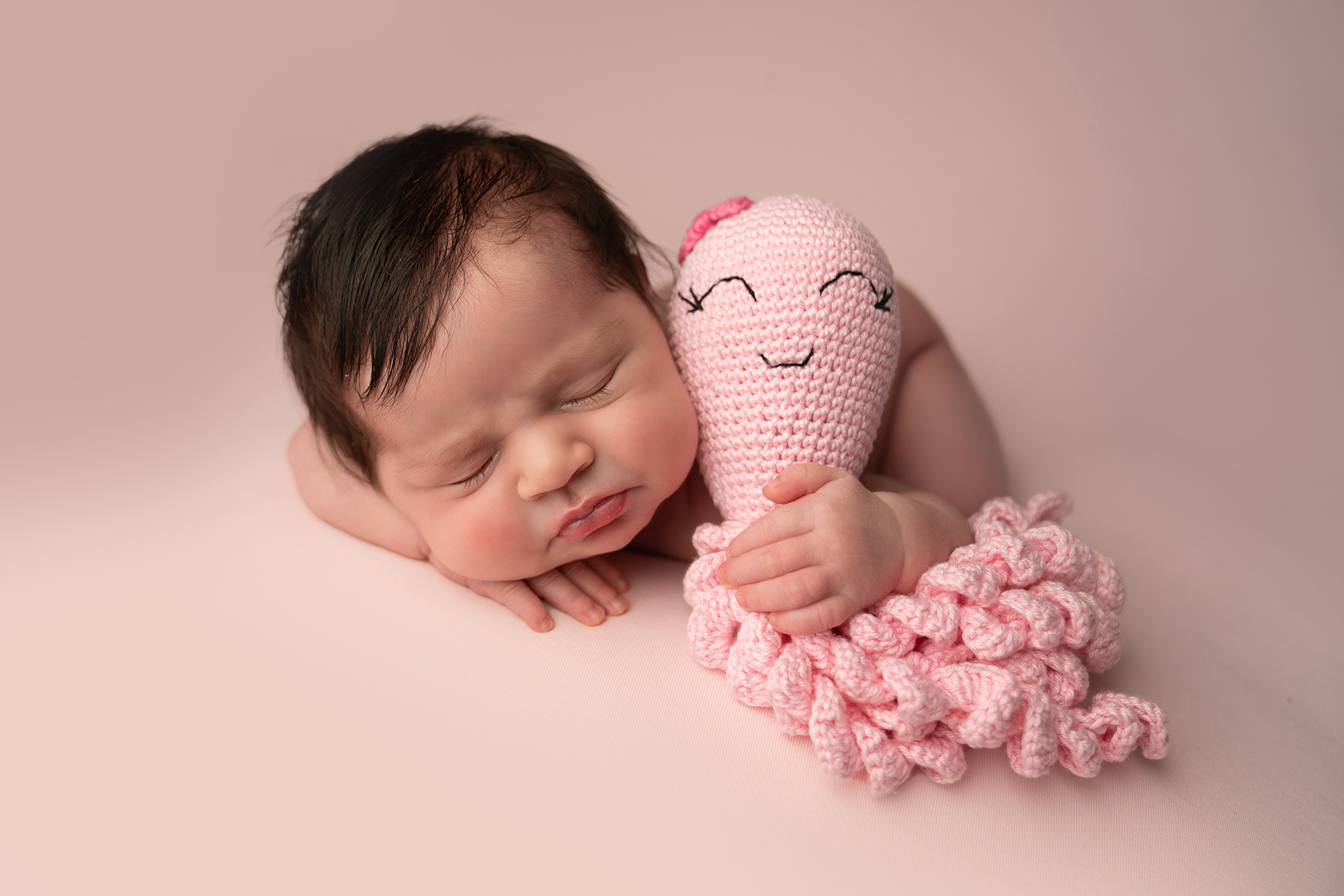 Newborn baby and toy in rugby