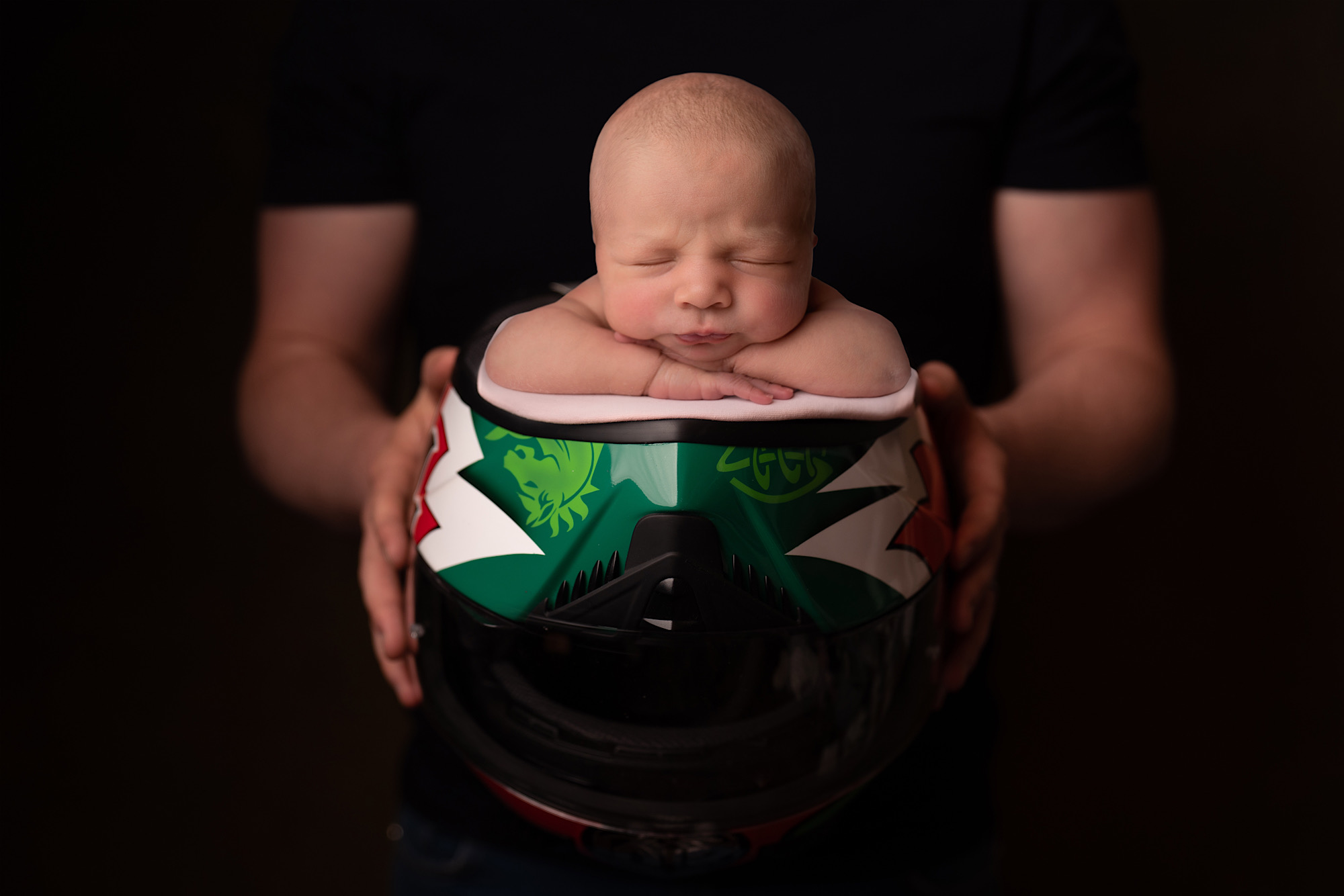 New born baby in bike helmet