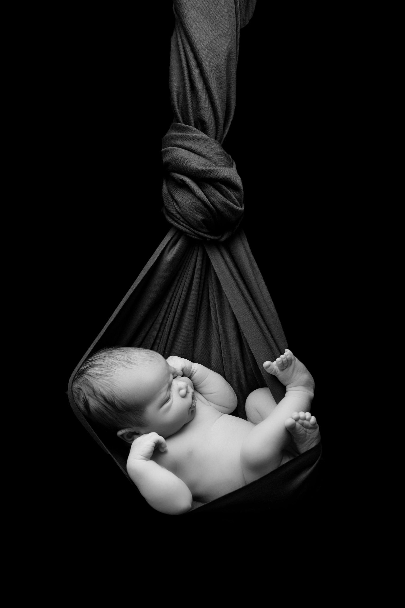 Newborn baby swinging photo