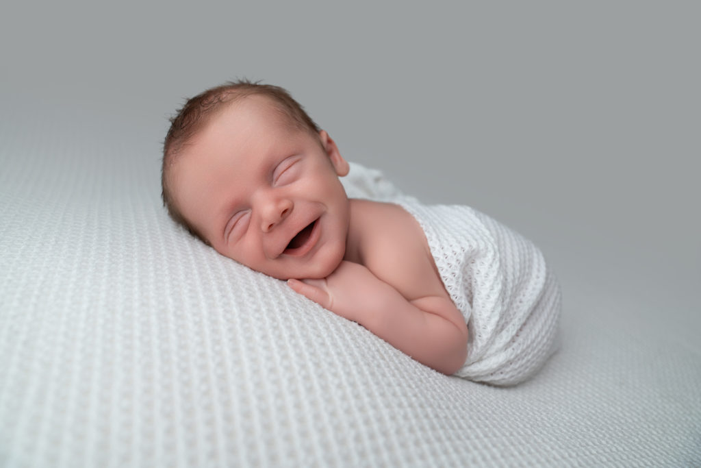 big smiles for newborn baby during a photography session at Lisa Scott Photography in Rugby.