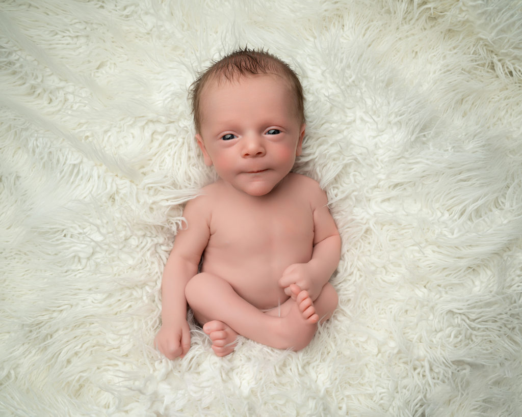 Wide-awake newborn baby during a photography session at Lisa Scott Photography in Rugby.